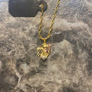 Black hills gold necklace with a pearl.